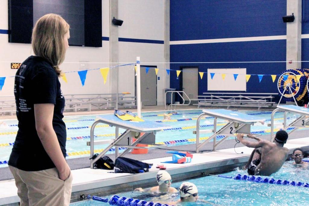 During practice, the new Swim Coach Amy Lamar perfects her students flip turns.  