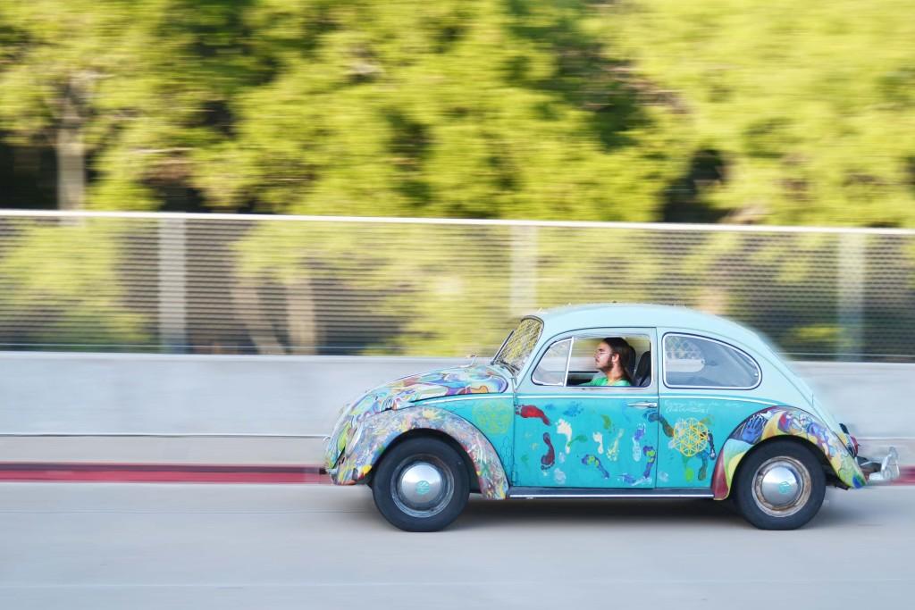 In the 66 Volkswagen he painted himself, senior Evan Jaworski drives home from school.