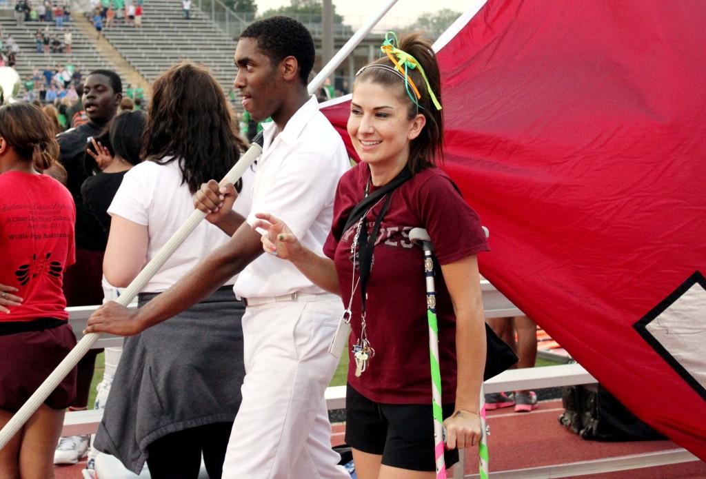 As she wobbles on one leg, teacher Chana Jayme, shows her spirit as Maroon Platoon adviser at every game.