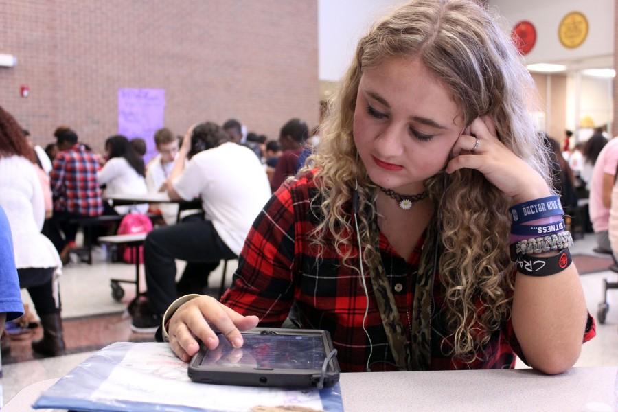 During her lunch, Morgan Burks listens to music to pass time, she says Music drowns everything out and recharges me for the day.