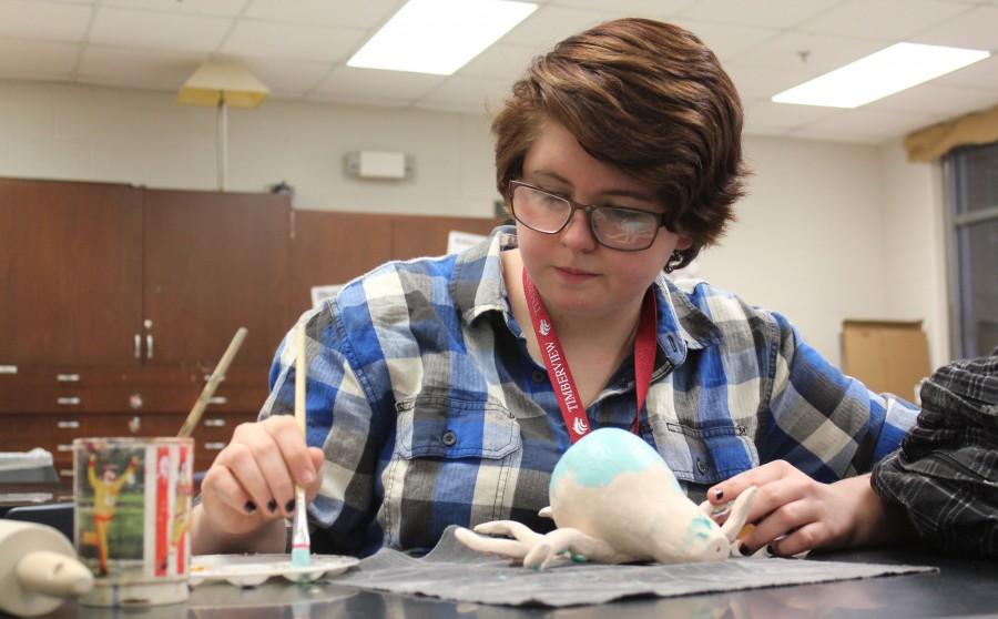 Finalizing her assignment, Katlyn Sutton paints her custom made wind chime. I like how [Ceramics is] a hands-on activity and I love learning a new skill Ive never had before. There is a lot of creativity and freedom to make what you want, Sutton said. 