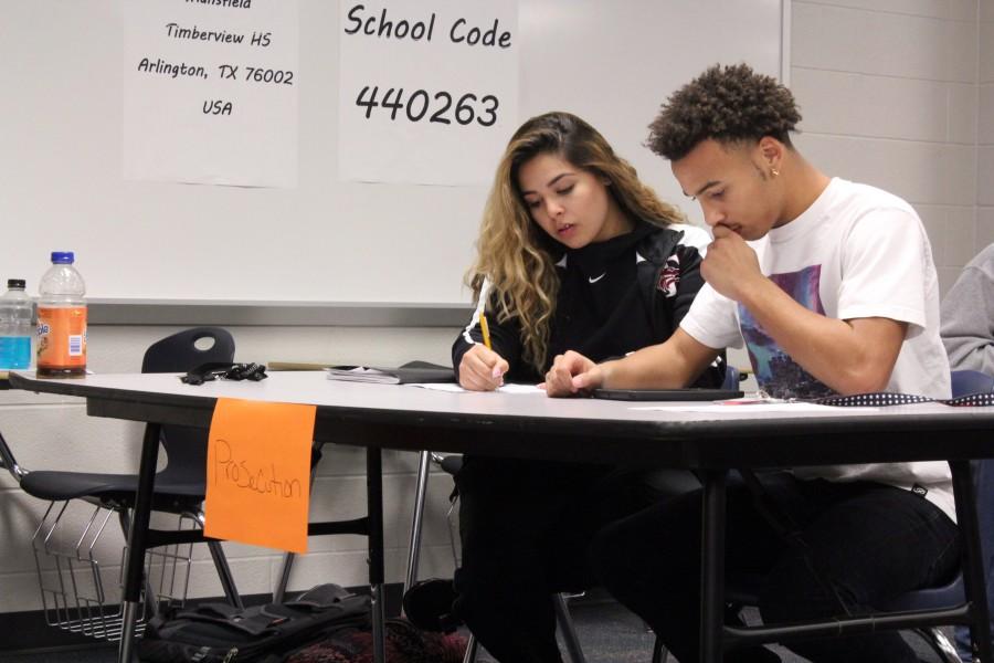 Preparing for a mock trial, juniors Julian Dunson and Lauren Salazar, look over their evidence against the defendants client. I feel like I have power and I can actually speak my mind, Dunson said. 