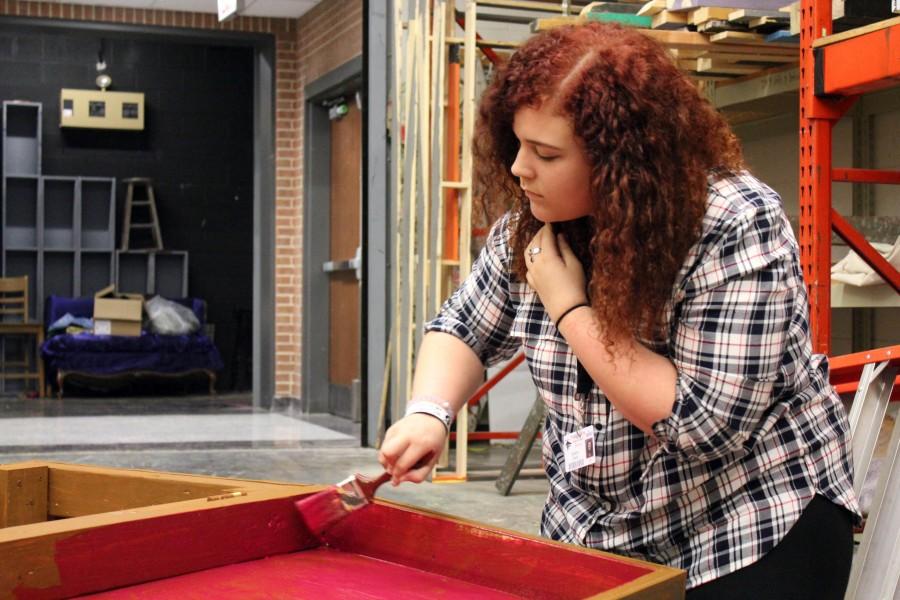 Painting a prop for the musical Tarzan, freshman Katelyn Regan helps prepare the scene. In the musical, Regan will be in an ensemble, preforming as an ape, a flower, and a sailor. We stay after school everyday until 5:30, expect on Fridays. Its a lot of fun and I love the movie.