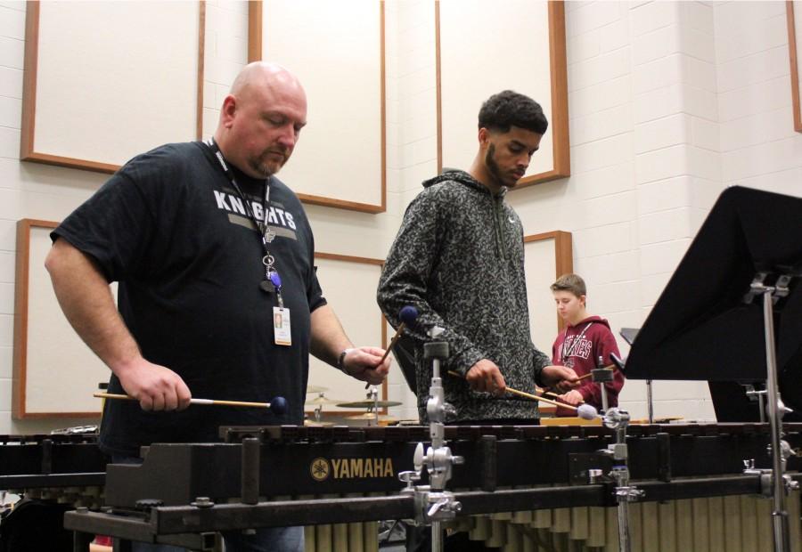 Preparing for the upcoming percussion concert, Marcus Dandridge receives help from band director Daniel Neimeyer during 4th block. 